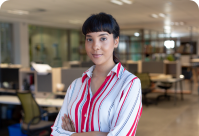 portrait-confident-young-biracial-businesswoman-with-arms-crossed-modern-workplace